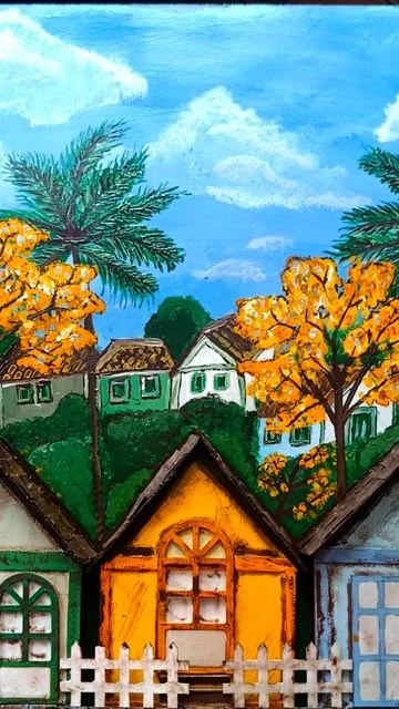 Quadro com casinhas coloridas em relevo, ipês amarelos e coqueiros pintados