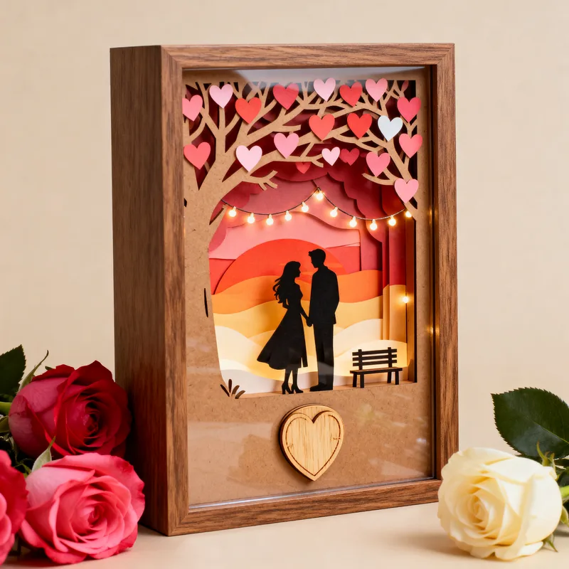 Ideia de quadro 3D para namorados, com silhueta do casal, árvore de corações e pôr do sol
