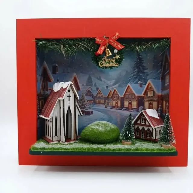 Quadro 3D de vila natalina com igrejinha branca, casinhas e neve, em moldura vermelha com sino